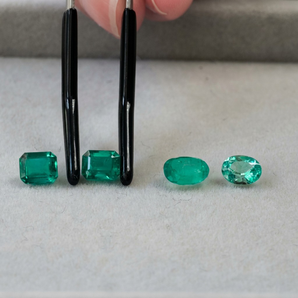 Several emeralds of similar size showing different hues, tones and saturation